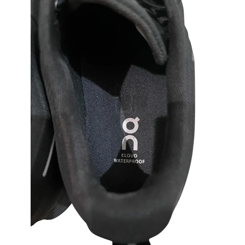 On Cloud waterproof running shoes for women in solid black.